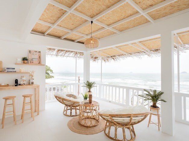 Relax on the ocean-view terrace with rattan chairs at Story II Pool Villa Hua-Hin, offering stunning sea vistas.