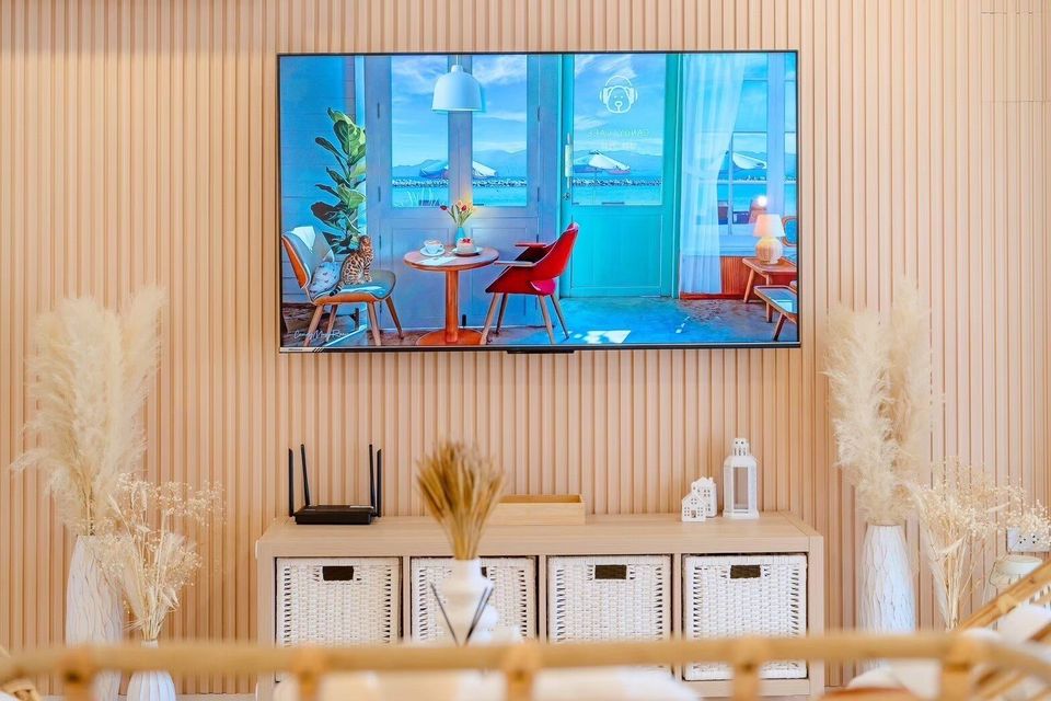 Modern living room with a large wall-mounted TV above a stylish entertainment unit at Story II Pool Villa Hua-Hin.