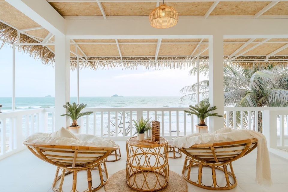 Relaxing rattan chairs on a beachfront balcony at Story II Pool Villa Hua-Hin, offering stunning ocean views.