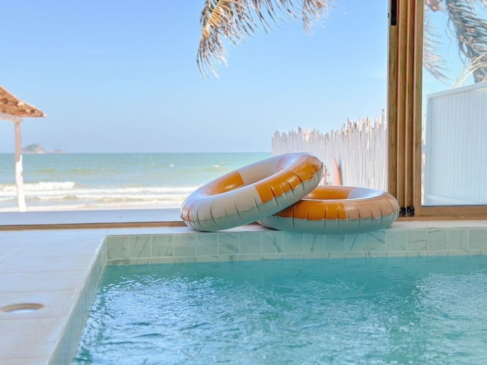 Poolside view with inflatable rings at Story II Pool Villa, เขาเต่า-หัวหิน. Relax by the sea in your private pool.