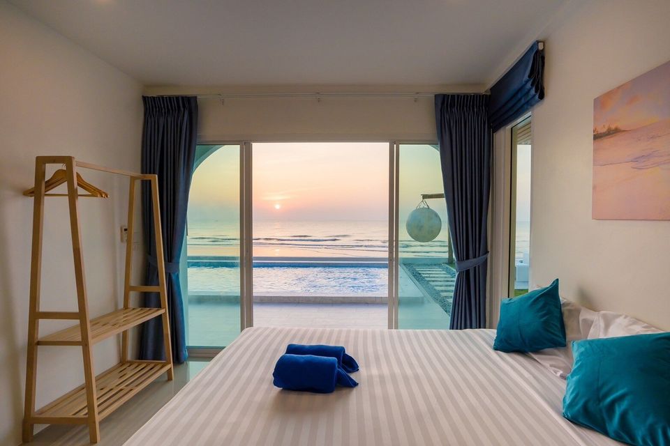 King bedroom with sunset view over the pool and sea at Sun Sea V Pool Villa