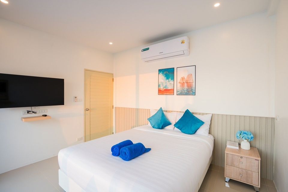King bedroom with wall-mounted TV at Sun Sea V Pool Villa