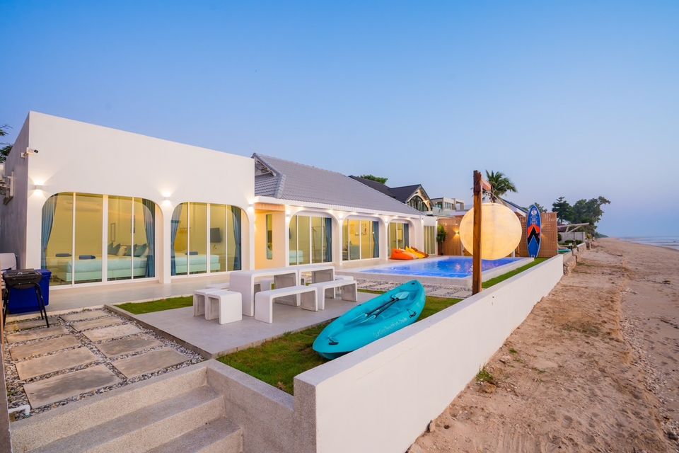 Sun Sea V Pool Villa beachfront exterior in Cha Am. Kayak and outdoor seating visible near the pool.