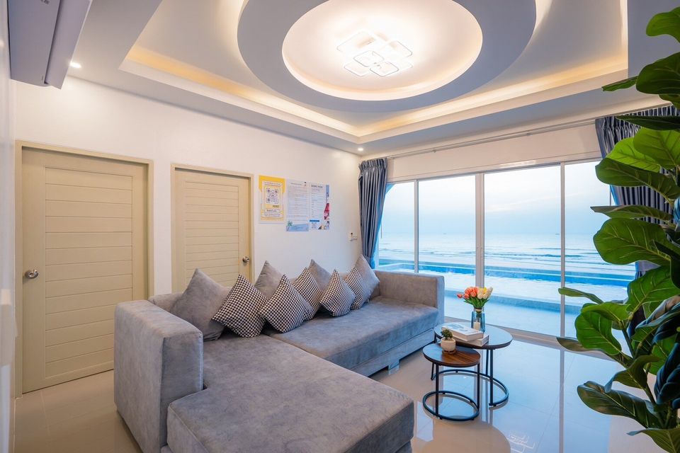Ocean-view living room with sectional sofa at Sun Sea V Pool Villa