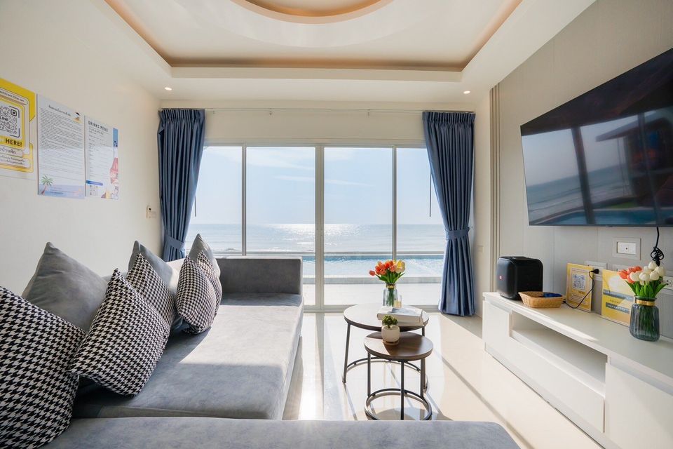 Sofa and TV area overlooking the ocean at Sun Sea V Pool Villa