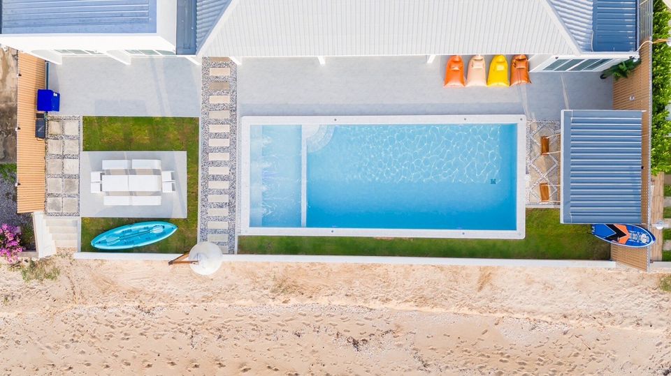 Top-down aerial view of the pool and beach at Sun Sea V Pool Villa