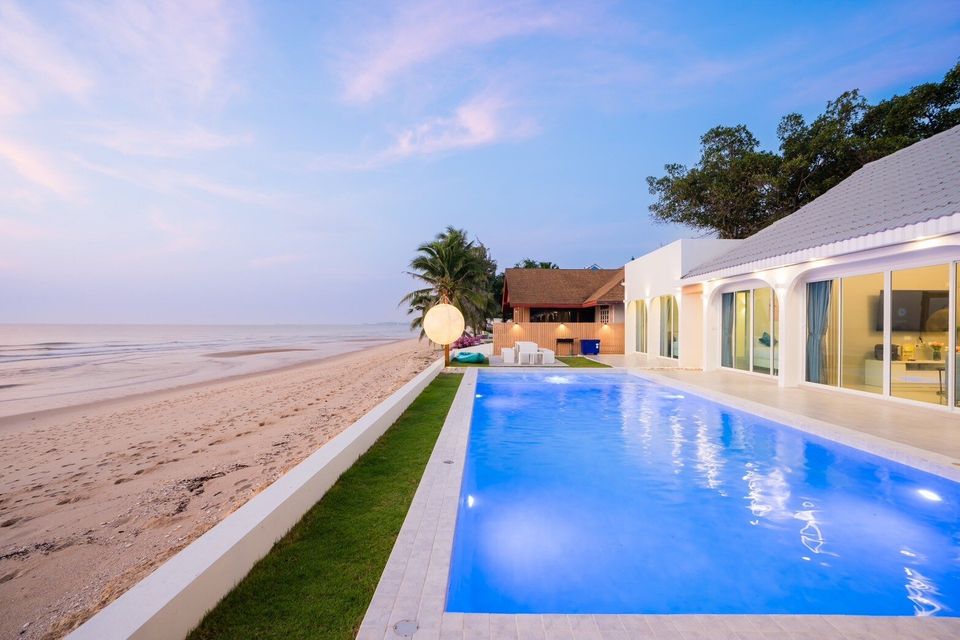 Beachfront pool and villa at sunset at Sun Sea V Pool Villa