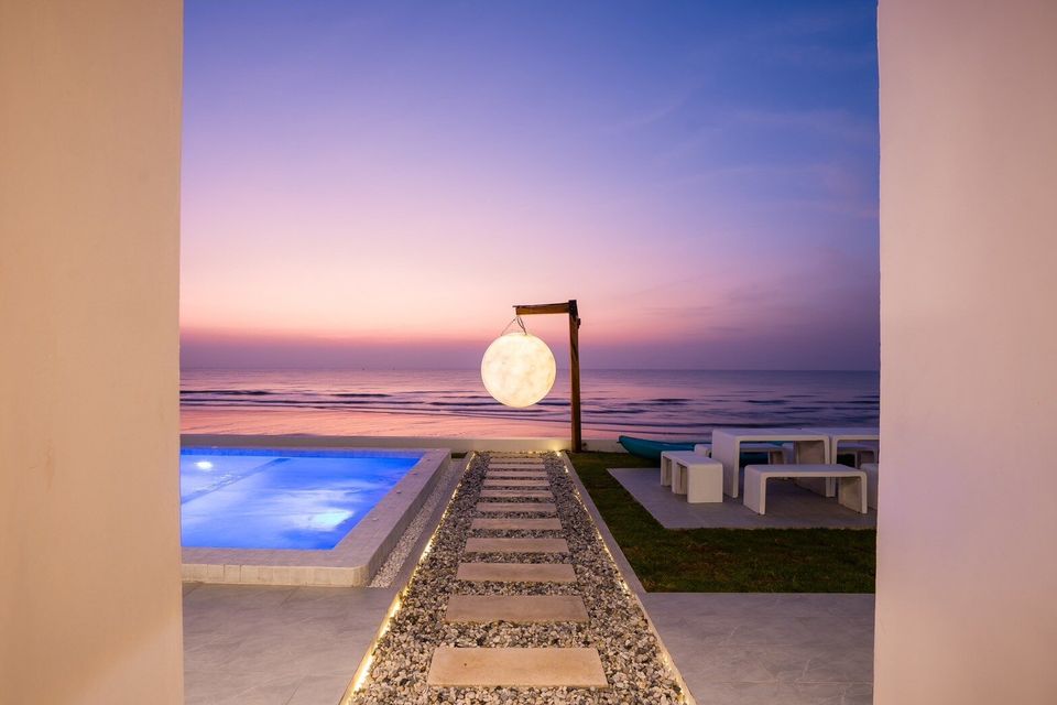 Moon sculpture and pathway to the sea at sunset at Sun Sea V Pool Villa