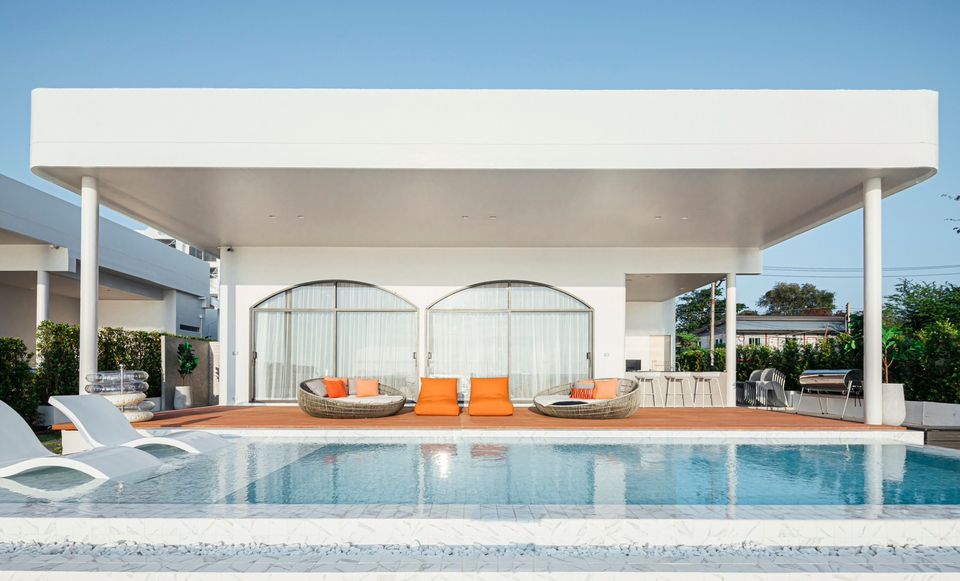 Poolside lounge chairs at SUN SEASON V POOL VILLA, Banglamung. Relax by the pool in this luxury pool villa.