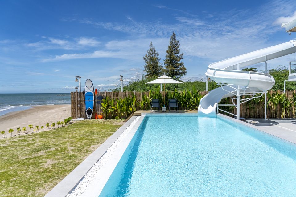 Talay Haus X Pool Villa in Cha-Am features a private pool with a water slide, sun loungers, and direct beach access.