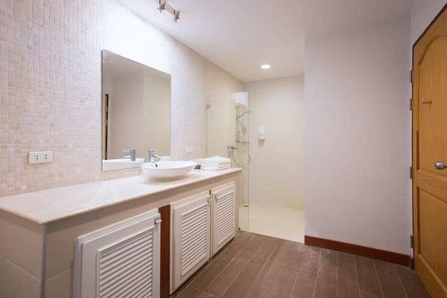 Modern bathroom at The Valley Khaoyai I pool villa, Khao Yai, featuring a vanity with vessel sink and walk-in shower.