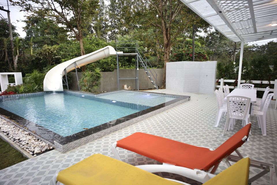 The Valley Khaoyai IX Villa in Khao Yai features a refreshing swimming pool with a fun water slide and sun loungers.