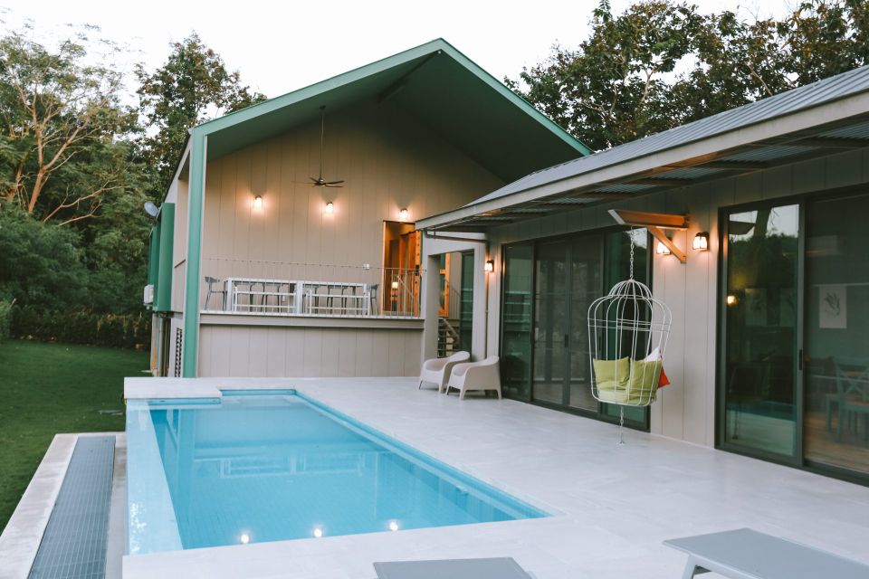 The Valley Khaoyai VI Villa pool view with chairs and hanging swing. Modern pool villa in หมูสี เขาใหญ่.
