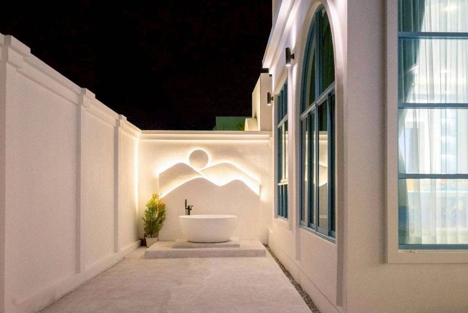 Outdoor bathtub with artistic mountain-themed lighting at Tierra V Pool Villa, Pattaya. Perfect for a relaxing soak.