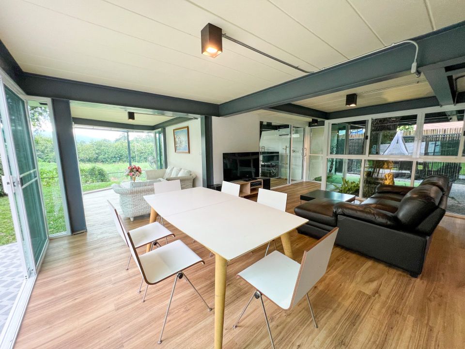 Bright dining area at Tree House III Pool Villa, เขาใหญ่. Modern table with seating for six.
