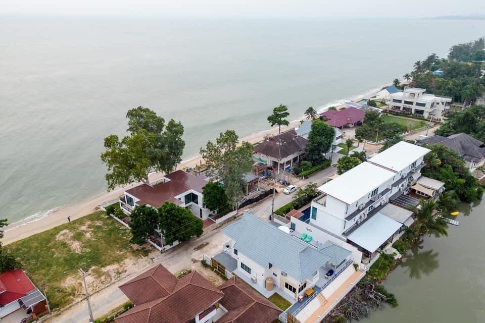 Aerial view of View Lay IV Pool Villa in Cha-Am, Thailand, showcasing its beachfront location and surrounding properties.