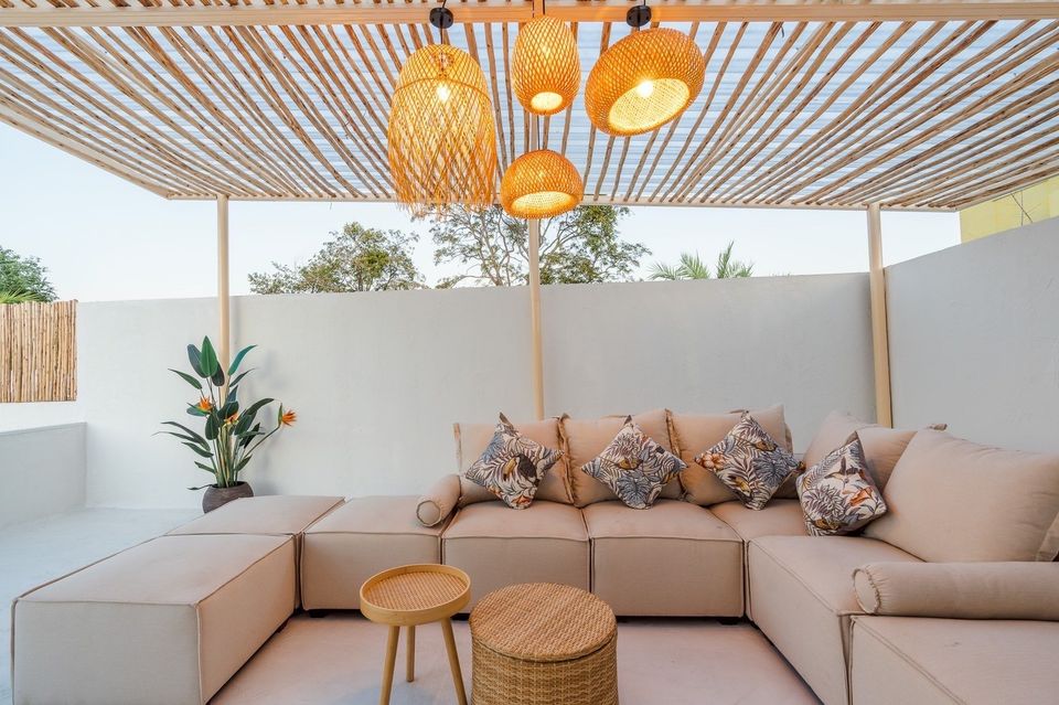 Stylish covered patio seating area at White Coco V Pool Villa, พัทยากลาง-นาเกลือ. Relax on the comfortable sofa and enjoy the